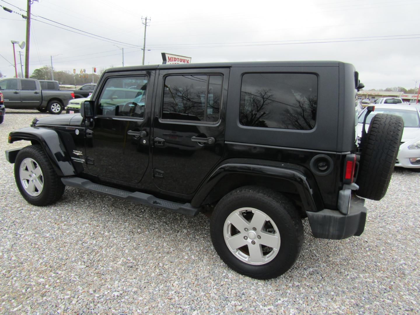 2008 Black Jeep Wrangler Unlimited Sahara 4WD (1J4GA591X8L) with an 3.8L V6 OHV 12V engine, Automatic transmission, located at 15016 S Hwy 231, Midland City, AL, 36350, (334) 983-3001, 31.306210, -85.495277 - Photo#5